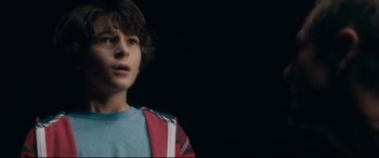 Movie still from “Incarnate” (2016), directed by Brad Peyton – A young boy is looking into the distance; Close Up shot, Low angle