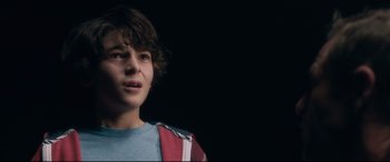 Movie still from “Incarnate” (2016), directed by Brad Peyton – A young boy is looking up at the sky; Close Up shot, Over the shoulder angle