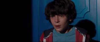 Movie still from “Incarnate” (2016), directed by Brad Peyton – A young boy is looking into the distance; Close Up shot, Over the shoulder angle
