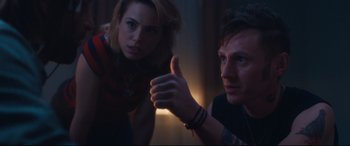 Movie still from “Incarnate” (2016), directed by Brad Peyton – A man and a woman sitting next to each other in a room; Close Up shot, Over the shoulder angle