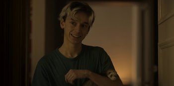 Movie still from “Into the Night” (2020), created by Jason George – A young man holding an animal in his arms; Close Up shot, Over the shoulder angle