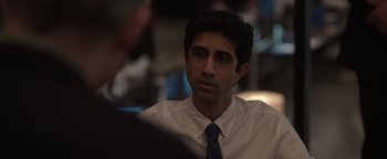 Movie still from “Kaleidoscope” (2023), directed by Mairzee Almas – A man wearing a white shirt and a blue tie; Close Up shot, Over the shoulder angle