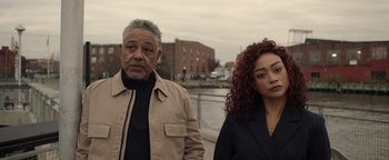 Movie still from “Kaleidoscope” (2023), directed by Mairzee Almas – A man and a woman standing next to each other near a body of water; Medium shot, Over the shoulder angle