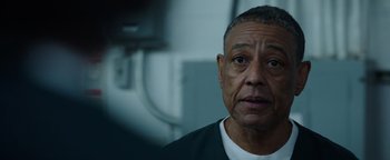 Movie still from “Kaleidoscope” (2023), directed by Mairzee Almas – An older man in a white shirt and black jacket; Close Up shot, Over the shoulder angle