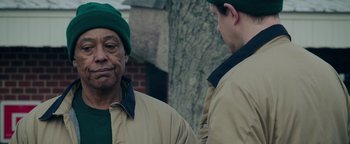 Movie still from “Kaleidoscope” (2023), directed by Mairzee Almas – A man wearing a green hat looking into a mirror; Close Up shot, Over the shoulder angle