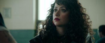 Movie still from “Kaleidoscope” (2023), directed by Mairzee Almas – A person with curly hair; Close Up shot, Over the shoulder angle