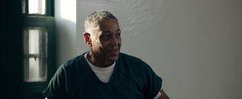 Movie still from “Kaleidoscope” (2023), directed by Mairzee Almas – An older woman in a white shirt and green shirt; Close Up shot, Over the shoulder angle