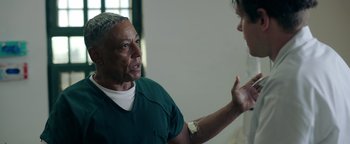 Movie still from “Kaleidoscope” (2023), directed by Mairzee Almas – A man talking to another man in a room; Close Up shot, Over the shoulder angle