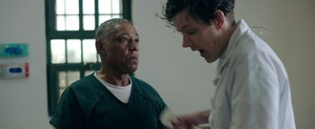 Movie still from “Kaleidoscope” (2023), directed by Mairzee Almas – Two men are talking in a jail cell; Medium shot, Over the shoulder angle