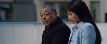 Movie still from “Kaleidoscope” (2023), directed by Mairzee Almas – An older man and a young woman standing next to each other; Close Up shot, Over the shoulder angle