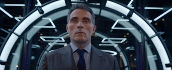 Movie still from “Kaleidoscope” (2023), directed by Mairzee Almas – A person wearing a suit and tie; Close Up shot, Low angle