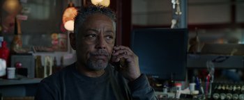 Movie still from “Kaleidoscope” (2023), directed by Mairzee Almas – A person talking on a cell phone; Close Up shot, Low angle