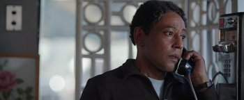 Movie still from “Kaleidoscope” (2023), directed by Mairzee Almas – A person wearing a jacket; Close Up shot, Over the shoulder angle