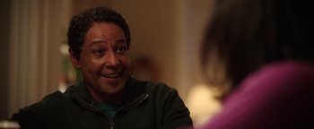 Movie still from “Kaleidoscope” (2023), directed by Mairzee Almas – A person sitting at a table; Close Up shot, Over the shoulder angle