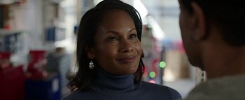 Movie still from “Kaleidoscope” (2023), directed by Mairzee Almas – A person wearing a sweater and looking to her left; Close Up shot, Over the shoulder angle