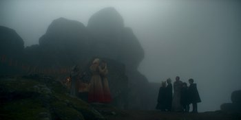 Movie still from “House of the Dragon” (2022), created by George R.R. Martin – A group of people standing on top of a mountain; Extreme Wide shot, Low angle