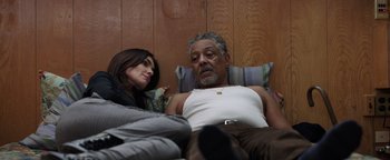 Movie still from “Kaleidoscope” (2023), directed by Mairzee Almas – A man and a woman laying in a bed; Medium shot, Low angle