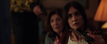 Movie still from “Kaleidoscope” (2023), directed by Mairzee Almas – Two women and a man are standing together; Close Up shot, Over the shoulder angle