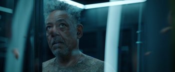 Movie still from “Kaleidoscope” (2023), directed by Mairzee Almas – A person wearing a ear piece; Close Up shot, Low angle