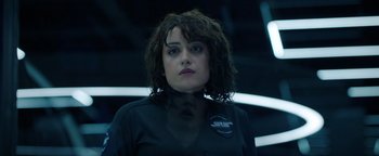 Movie still from “Kaleidoscope” (2023), directed by Mairzee Almas – A woman in a black shirt is looking at the camera; Close Up shot, Over the shoulder angle