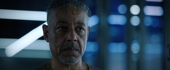 Movie still from “Kaleidoscope” (2023), directed by Mairzee Almas – A person wearing a necklace; Close Up shot, Over the shoulder angle