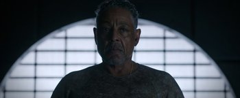 Movie still from “Kaleidoscope” (2023), directed by Mairzee Almas – A person wearing a shirt; Close Up shot, Low angle