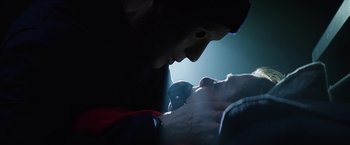 Movie still from “Kidnapping Stella” (2019), directed by Thomas Sieben – A man is looking at a baby in the dark; Close Up shot, Over the shoulder angle