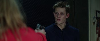 Movie still from “Kidnapping Stella” (2019), directed by Thomas Sieben – A young man with spiky hair is taking a picture of himself; Close Up shot, Over the shoulder angle