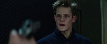 Movie still from “Kidnapping Stella” (2019), directed by Thomas Sieben – A young man with spiky blond hair is looking at the camera; Close Up shot, Low angle