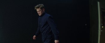 Movie still from “Kidnapping Stella” (2019), directed by Thomas Sieben – A young man in a black suit is walking; Medium shot, Low angle