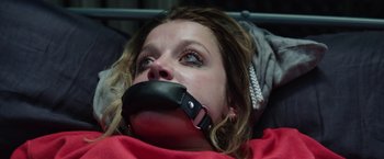 Movie still from “Kidnapping Stella” (2019), directed by Thomas Sieben – A woman with her mouth taped shut is laying in a bed; Close Up shot, Overhead angle