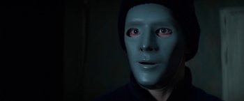 Movie still from “Kidnapping Stella” (2019), directed by Thomas Sieben – A man wearing a blue mask and a black hat; Close Up shot, Over the shoulder angle