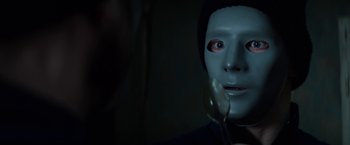 Movie still from “Kidnapping Stella” (2019), directed by Thomas Sieben – A person wearing a mask and holding a spoon; Close Up shot, Over the shoulder angle