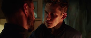 Movie still from “Kidnapping Stella” (2019), directed by Thomas Sieben – A man stares at another man with a beard; Close Up shot, Over the shoulder angle