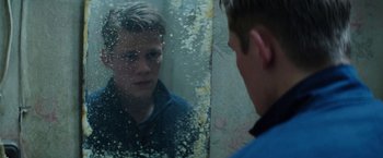 Movie still from “Kidnapping Stella” (2019), directed by Thomas Sieben – A man looking at himself in the mirror; Close Up shot, Over the shoulder angle