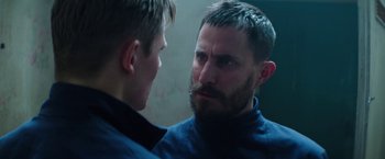 Movie still from “Kidnapping Stella” (2019), directed by Thomas Sieben – A man with a goatee is looking at another man's face; Close Up shot, Over the shoulder angle