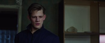 Movie still from “Kidnapping Stella” (2019), directed by Thomas Sieben – A young man in a black shirt is looking at the camera; Close Up shot, Low angle