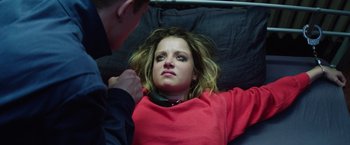 Movie still from “Kidnapping Stella” (2019), directed by Thomas Sieben – A woman laying on a bed with a man touching her neck; Close Up shot, Overhead angle