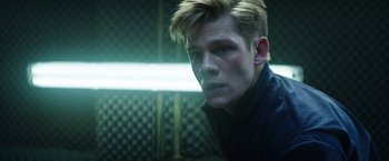 Movie still from “Kidnapping Stella” (2019), directed by Thomas Sieben – A man with blonde hair and a blue jacket; Close Up shot, Low angle