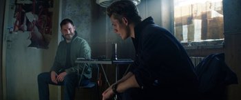 Movie still from “Kidnapping Stella” (2019), directed by Thomas Sieben – A man sitting in front of a mirror in a room; Medium shot, Over the shoulder angle