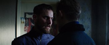 Movie still from “Kidnapping Stella” (2019), directed by Thomas Sieben – A man with a goatee and beard talking to another man; Close Up shot, Over the shoulder angle