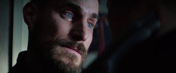 Movie still from “Kidnapping Stella” (2019), directed by Thomas Sieben – A person with a beard and blue eyes; Extreme Close Up shot, Over the shoulder angle