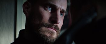 Movie still from “Kidnapping Stella” (2019), directed by Thomas Sieben – A man with a beard and blue eyes; Extreme Close Up shot, Over the shoulder angle