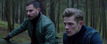 Movie still from “Kidnapping Stella” (2019), directed by Thomas Sieben – Two young men sitting in the woods looking at the camera; Close Up shot, Over the shoulder angle
