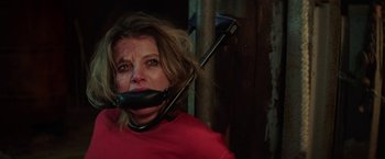 Movie still from “Kidnapping Stella” (2019), directed by Thomas Sieben – A woman in a red shirt is tied to a wooden pole; Close Up shot, Low angle