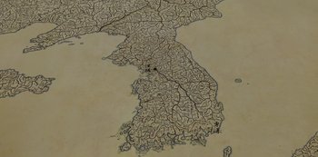 Movie still from “Kingdom” (2019), created by Eun-hee Kim – An old map of the korean peninsula with rivers; Extreme Close Up shot, High angle