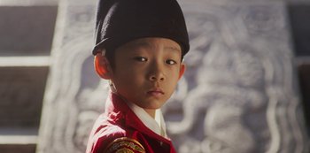 Movie still from “Kingdom” (2019), created by Eun-hee Kim – A young boy wearing a red jacket and a black hat; Close Up shot, High angle