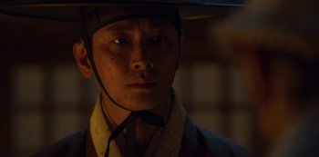 Movie still from “Kingdom” (2019), created by Eun-hee Kim – A man with a helmet on his head; Close Up shot, Low angle