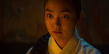 Movie still from “Kingdom” (2019), created by Eun-hee Kim – A young man in a white shirt and a black tie; Close Up shot, Over the shoulder angle