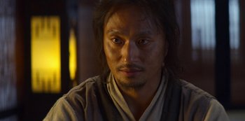 Movie still from “Kingdom” (2019), created by Eun-hee Kim – A person wearing a robe looking at the camera; Close Up shot, Low angle